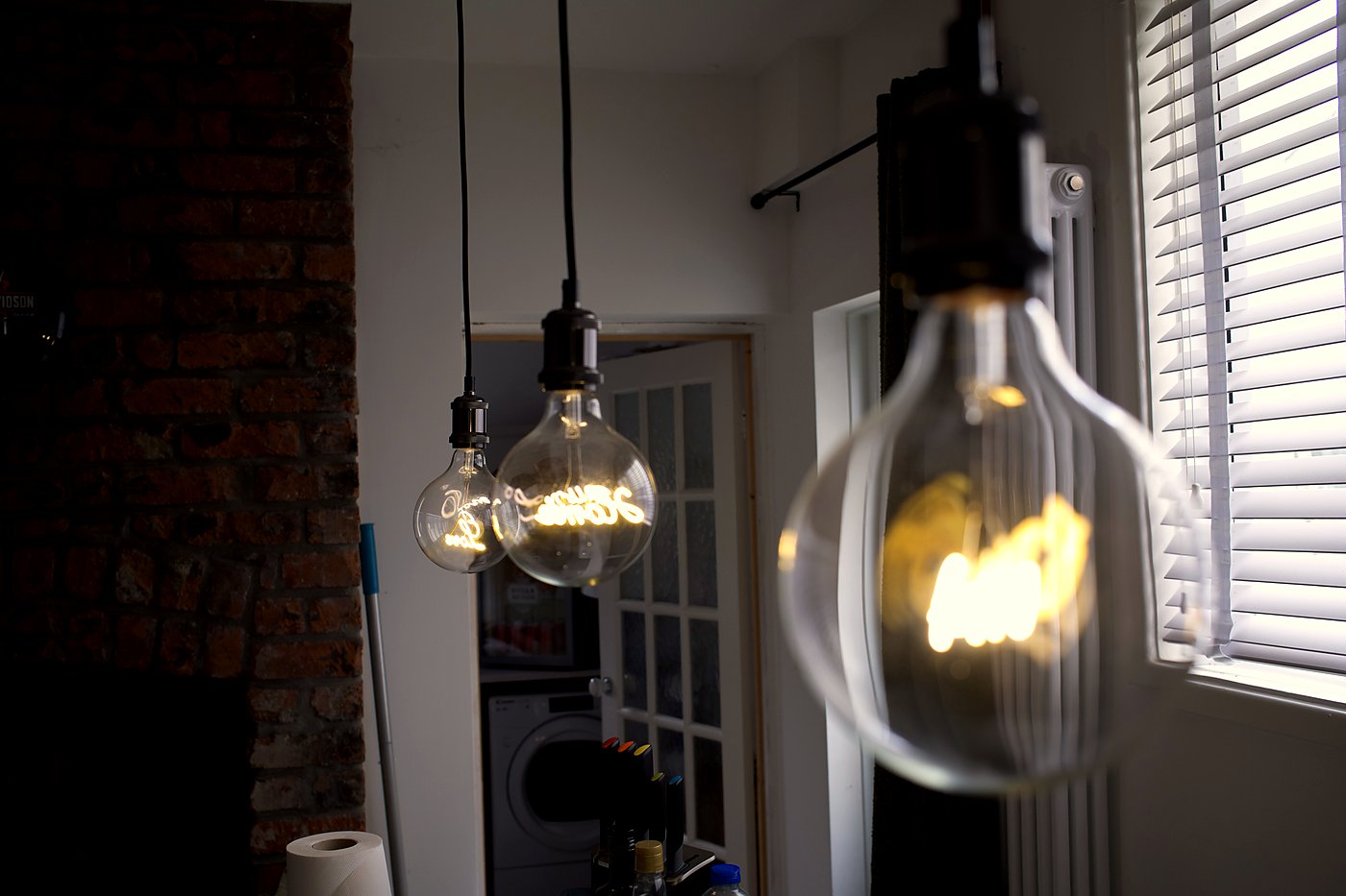 Globe pendant light installation in a modern kitchen, Cardiff — bespoke lighting by Livvingale