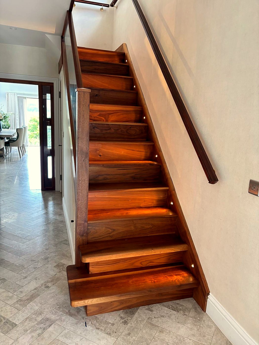 Walnut staircase with integrated LED step lighting installation, South Wales — by Livvingale